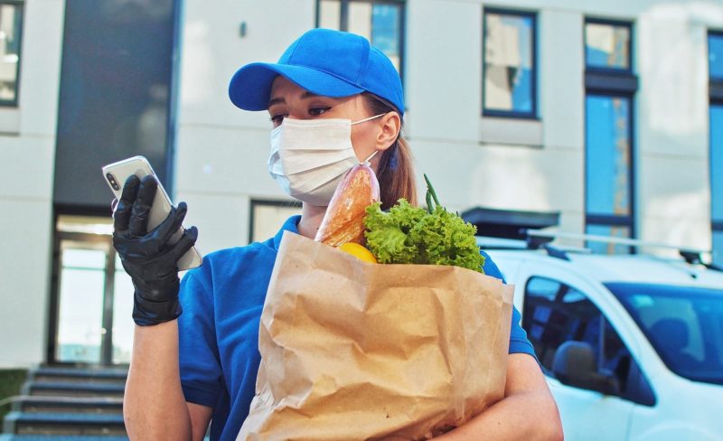 Close up of the caucasian attractive young women worker of the supermarket delivery typing on the