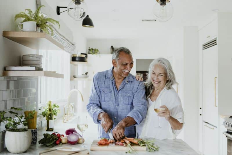 Elderly couple cooking in a kitchen