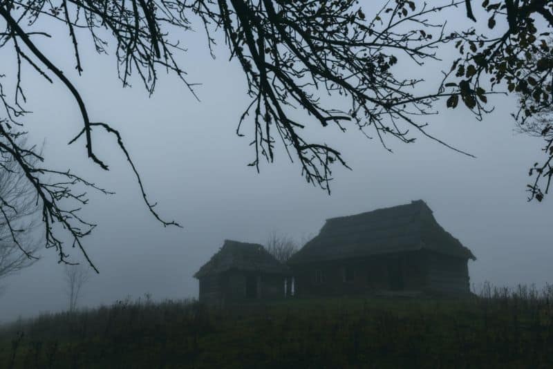 Alone house on foggy meadow