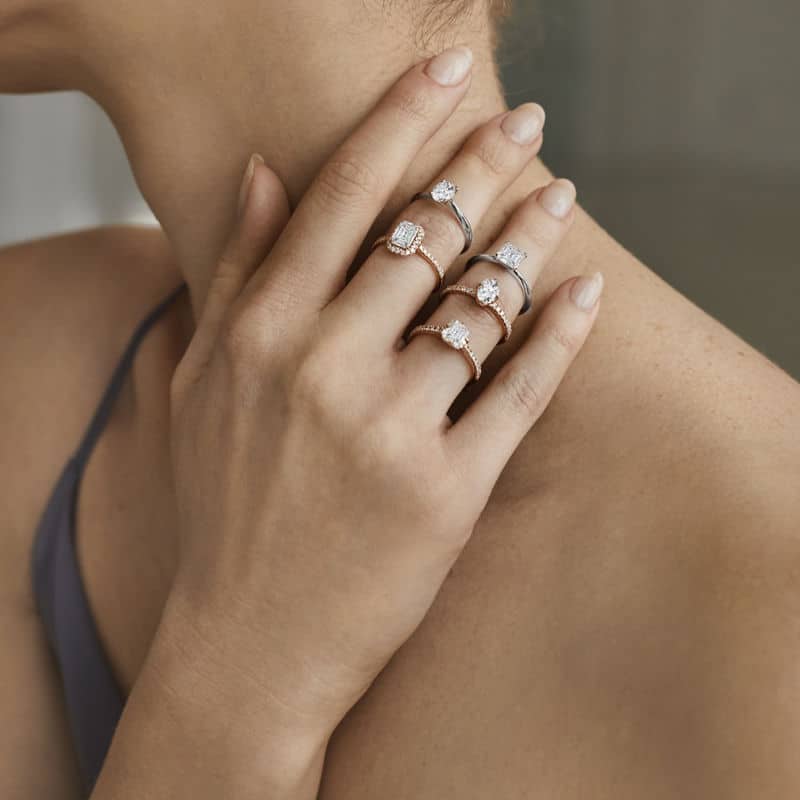 Une femme portant une bague ornée de trois diamants.