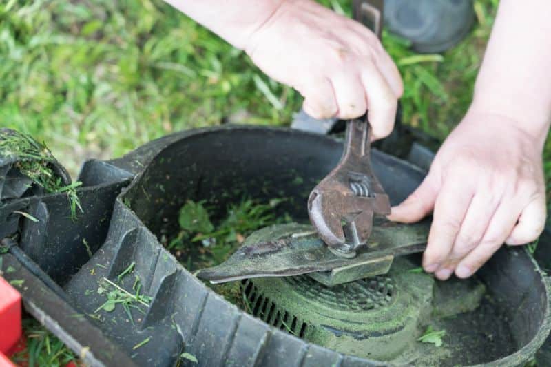 Man repairing a lawn mower