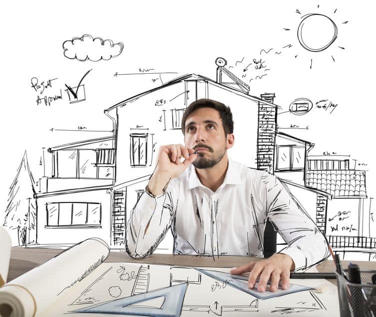 Un Homme Est Assis à Un Bureau Avec Des Plans Devant Lui.