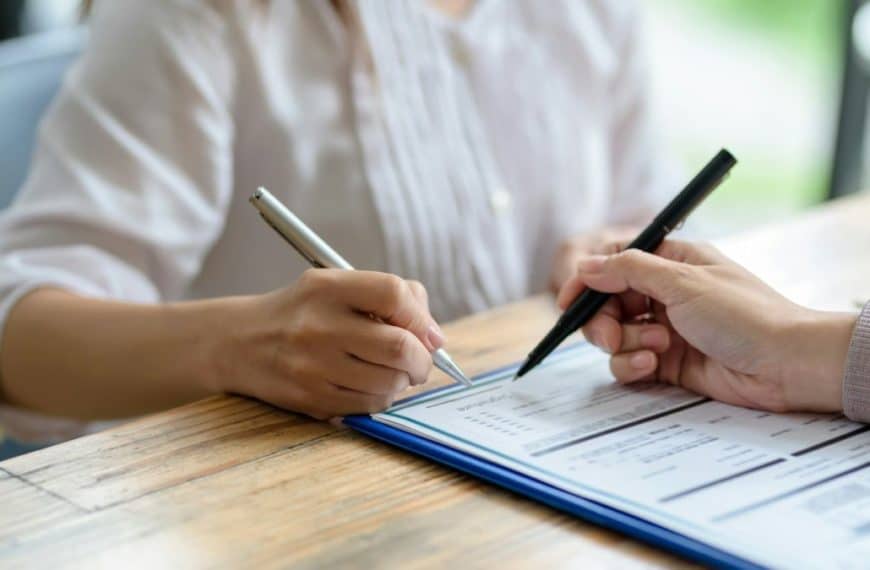 Business people sitting holding pen signing contract paper, lease mortgage.