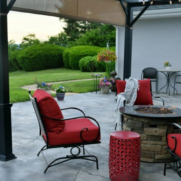 Comfortable outdoor living space with a gas fire pit during the day