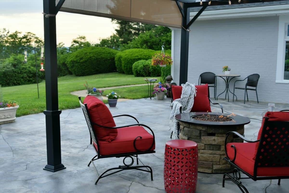Comfortable outdoor living space with a gas fire pit during the day