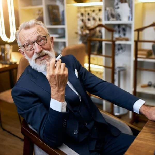 Portrait of senior smoker with e-cigarette in hands