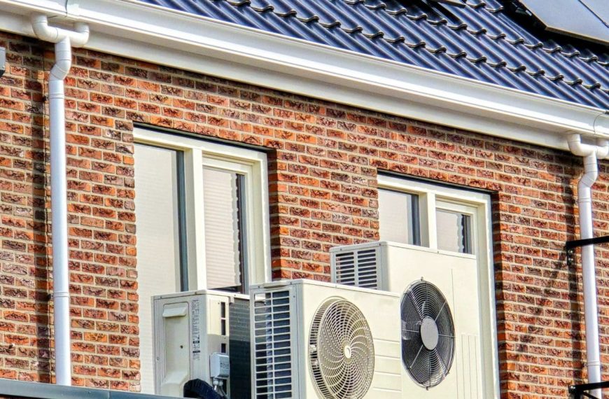 Air Source Heat Pump Unit Installed Outdoors At A Modern Home With Solar Panels In The Netherlands