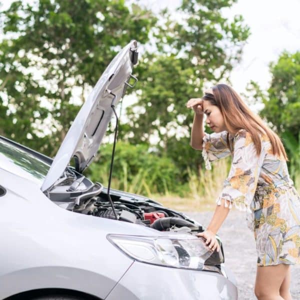 Young woman was having a bad car breakdown and felt frustrated while traveling