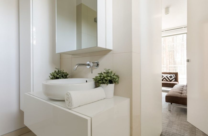 Light bathroom with small mirror