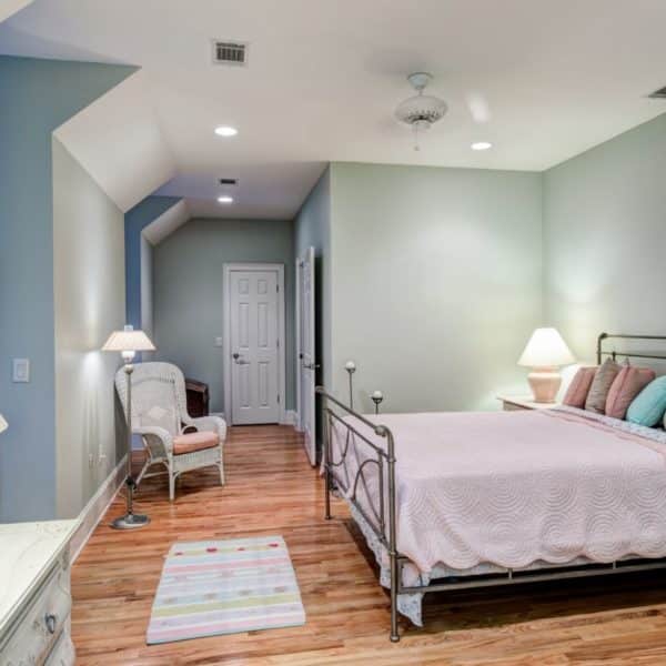 Tasteful attic bedroom with hard wood floors