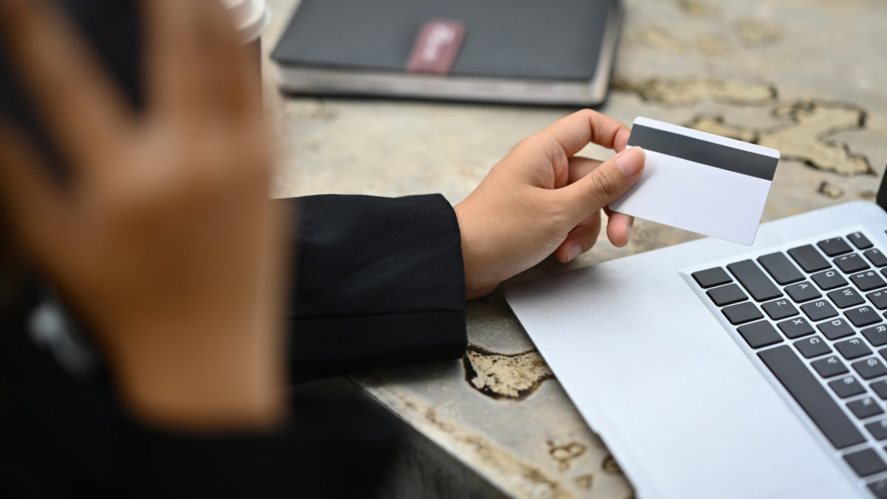 Cropped Shot Of Young Woman Holding Credit Card And Calling To Bank Or Customer Service