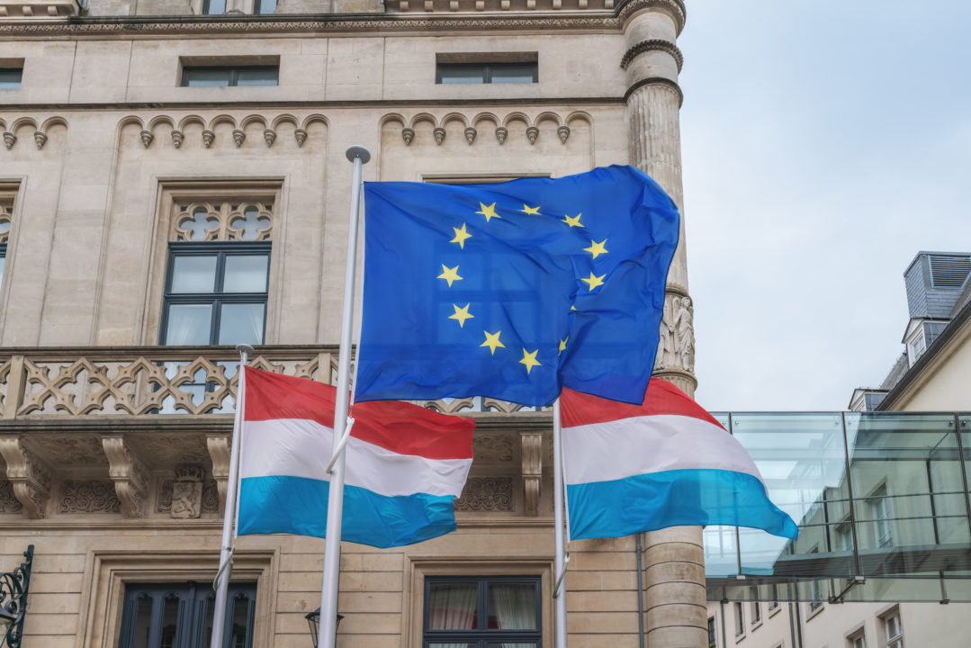 European Union And Luxembourg Flags Waving In Front Of The Chamb