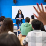 University Students Raising Hand During Lesson At Institute